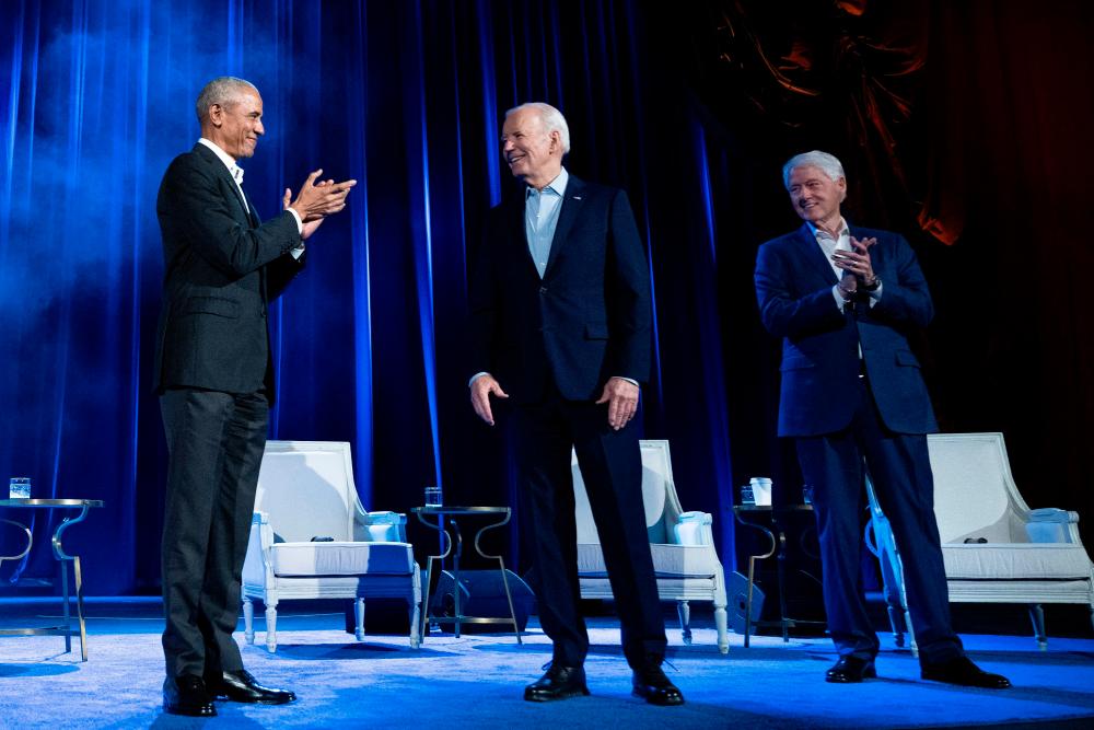 Former US President Barack Obama (L) and former US President Bill Clinton (R) clap for US President Joe Biden during a campaign fundraising event at Radio City Music Hall in New York City on March 28, 2024/AFPPix