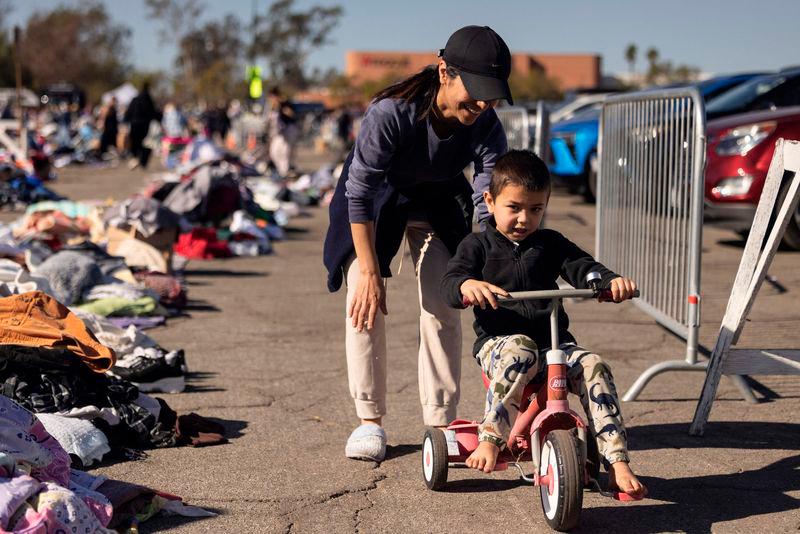 Evacuees from the Eaton Fire dwell among heaps of clothes displayed on the ground at a donation center in Santa Anita Park, Arcadia, California, on January 13, 2025. AFPPix