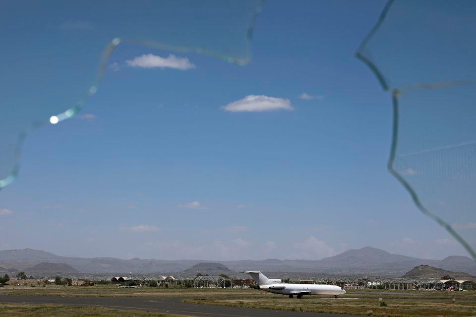 A cargo plane carrying relief supplies is pictured through a broken glass after it landed at Sanaa airport in Sanaa, Yemen September 8, 2020. REUTERSPIX