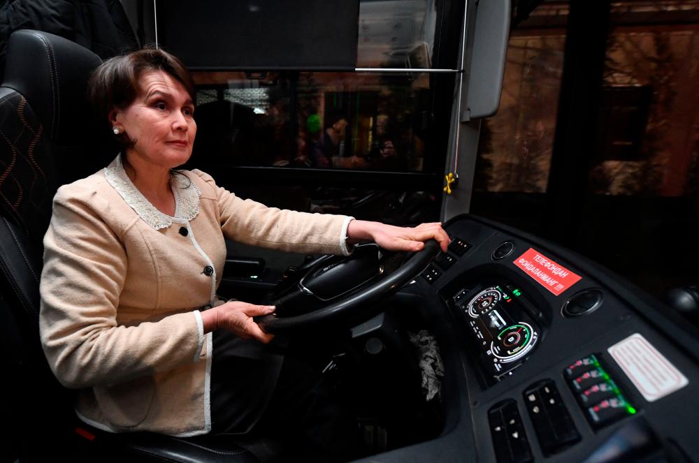 Bus driver Saodat Shermatova, 49, drives an electric bus in Tashkent early on March 5, 2024. Saodat Shermatova “cried with joy” when she found out she could drive a bus after Uzbekistan, a predominantly Muslim ex-Soviet country, lifted a ban on female bus drivers last month/AFPPix