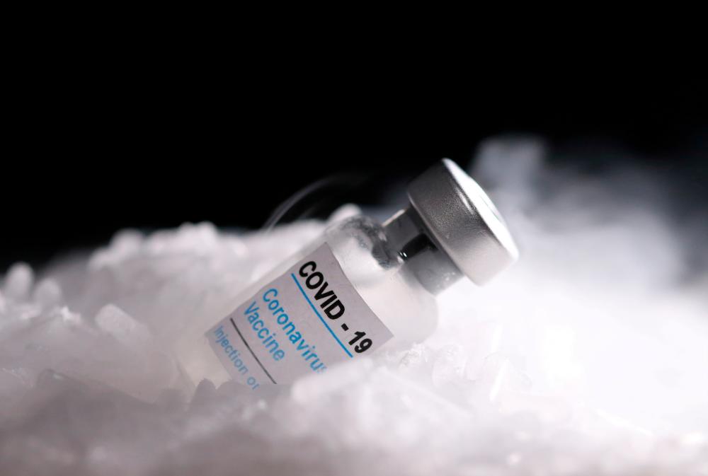 FILE PHOTO: Vials labelled Covid-19 Coronavirus Vaccine are placed on dry ice in this illustration taken, December 4, 2020. — Reuters