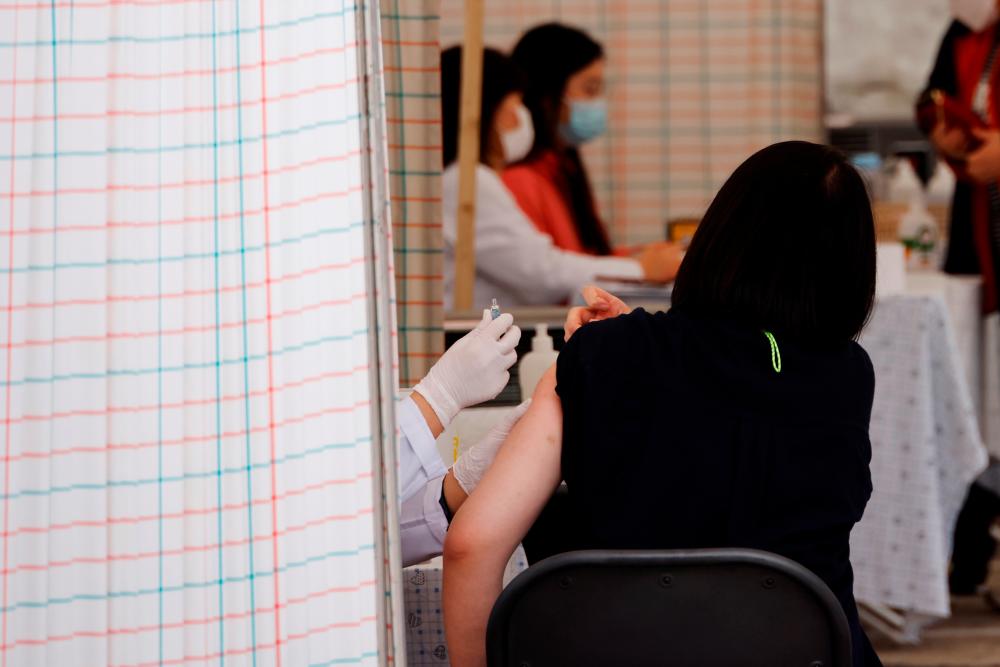 A woman gets an influenza vaccine at a hospital in Seoul, South Korea, October 21, 2020. — Reuters