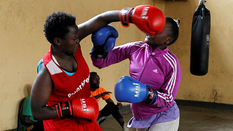Faith Macharia and Vanessa Wanjera (right) spar during a training session at the Mathare North Boxing Club. – REUTERSPIX