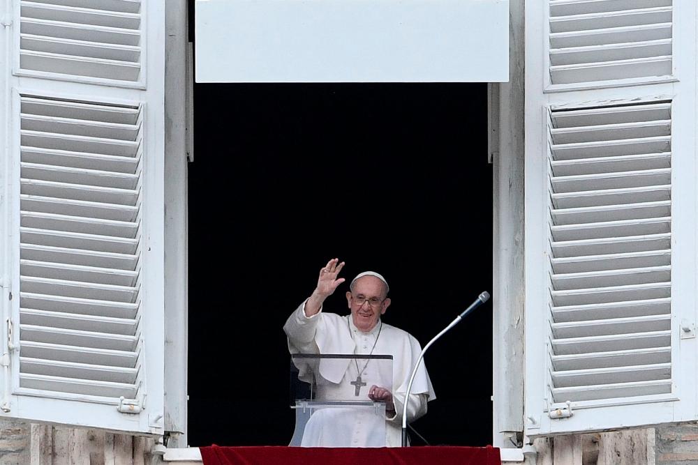 Pope Francis waves as he delivers the Sunday Angelus prayer from the window of his study overlooking St.Peter’s Square at the Vatican on July 25, 2021. -AFP