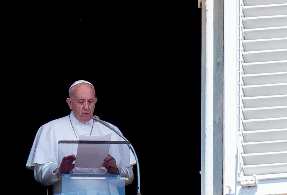 Pope Francis addresses the crowd from the window of the apostolic palace overlooking Saint Peter's square in the Vatican during his Sunday Angelus prayer on July 21, 2019. — AFP