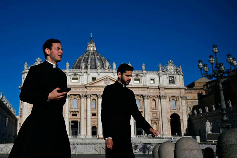 Priests walk past St Peter’s Basilica in the background, following the funeral of the Pope and ahead of the conclave, at St Peter’s Square in The Vatican, on May 2, 2025. AFPpix