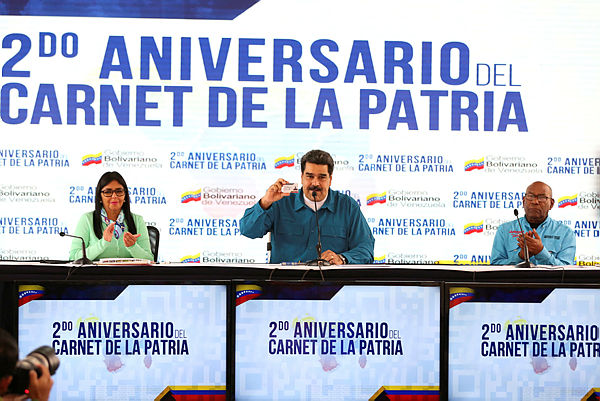 This handout picture released by the Venezuelan presidency shows Venezuelan President Nicolas Maduro (C) talking next to Vice-President Delcy Rodriguez (L) and Education Minister Aristobulo Isturiz during a television programme in Caracas — AFP