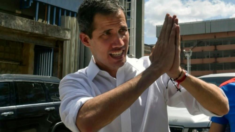 Venezuelan opposition leader and self declared acting president Juan Guaido gestures to supporters at the end of a rally with volunteers. — AFP