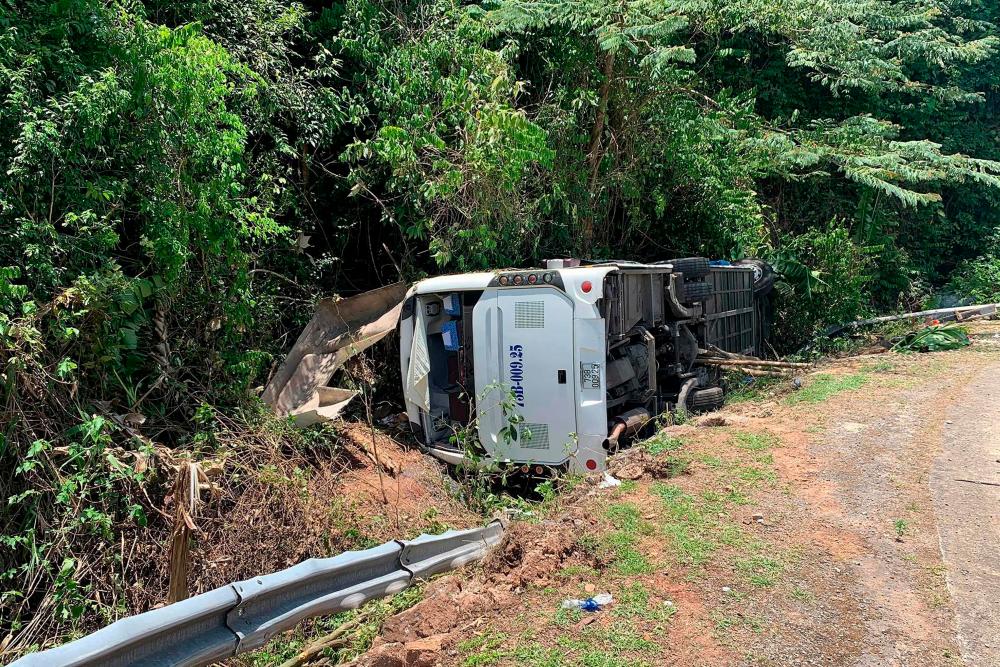 This picture taken and released by the Vietnam News Agency on July 26, 2020 shows the wreckage of a bus that crashed while carrying passengers on a high school reunion trip in central Quang Binh province. — AFP