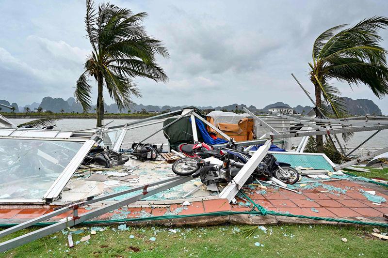 This picture shows swept motorbikes with the debris of destroyed waiting lounges on the shore after Super Typhoon Yagi hit Ha Long bay, in Quang Ninh province, on September 8, 2024. - AFPPIX