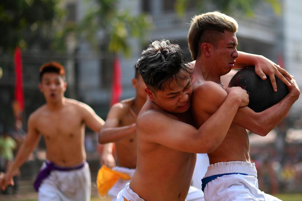 This photograph taken on Feb 9, 2019 shows Vietnamese men competing for the prized jackfruit wooden ball during the traditional Vat Cau or ball wrestling festival on the fifth day of Lunar New Year celebrations, referred to in Vietnam as Tet, at Thuy Linh pagoda in Hanoi. — AFP