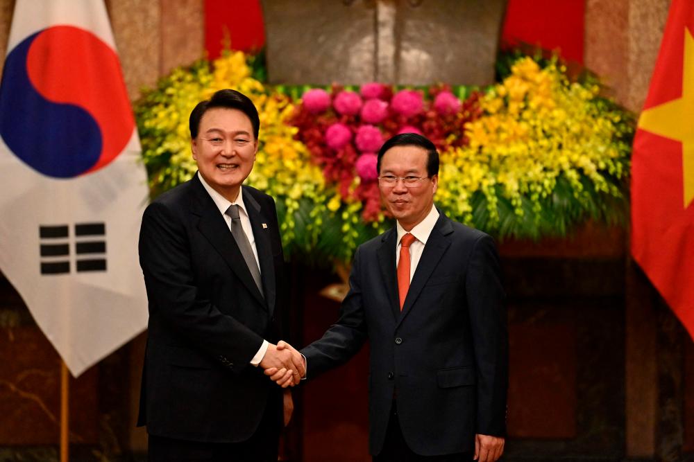 South Korea’s President Yoon Suk Yeol (L) and Vietnam’s President Vo Van Thuong shake hands during a welcoming ceremony at the Presidential Palace in Hanoi on June 23, 2023. AFPPIX