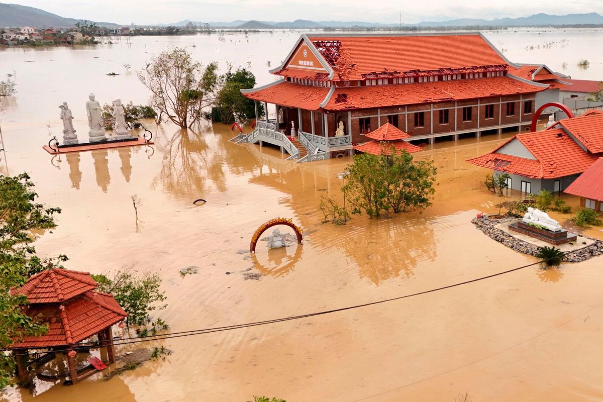 Flood waters surrounding a pagoda complex after typhoon Bualoi passed over Lam Thanh commune in Nghe An province on September 30, 2025. (Photo by Phan Duy / AFP)