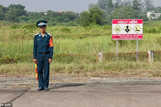 A Vietnamese soldier stands next to a sign warning of toxic hazard at Bien Hoa air base, on the outskirts of Ho Chi Minh City. — AFP