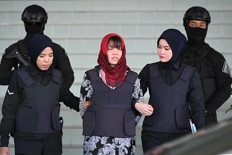 In this file photo taken on March 14, 2019, Vietnamese national Doan Thi Huong (C), accused of murdering Kim Jong Nam, the half brother of North Korean leader Kim Jong Un, leaves Shah Alam High Court escorted by police, outside Kuala Lumpur. — AFP