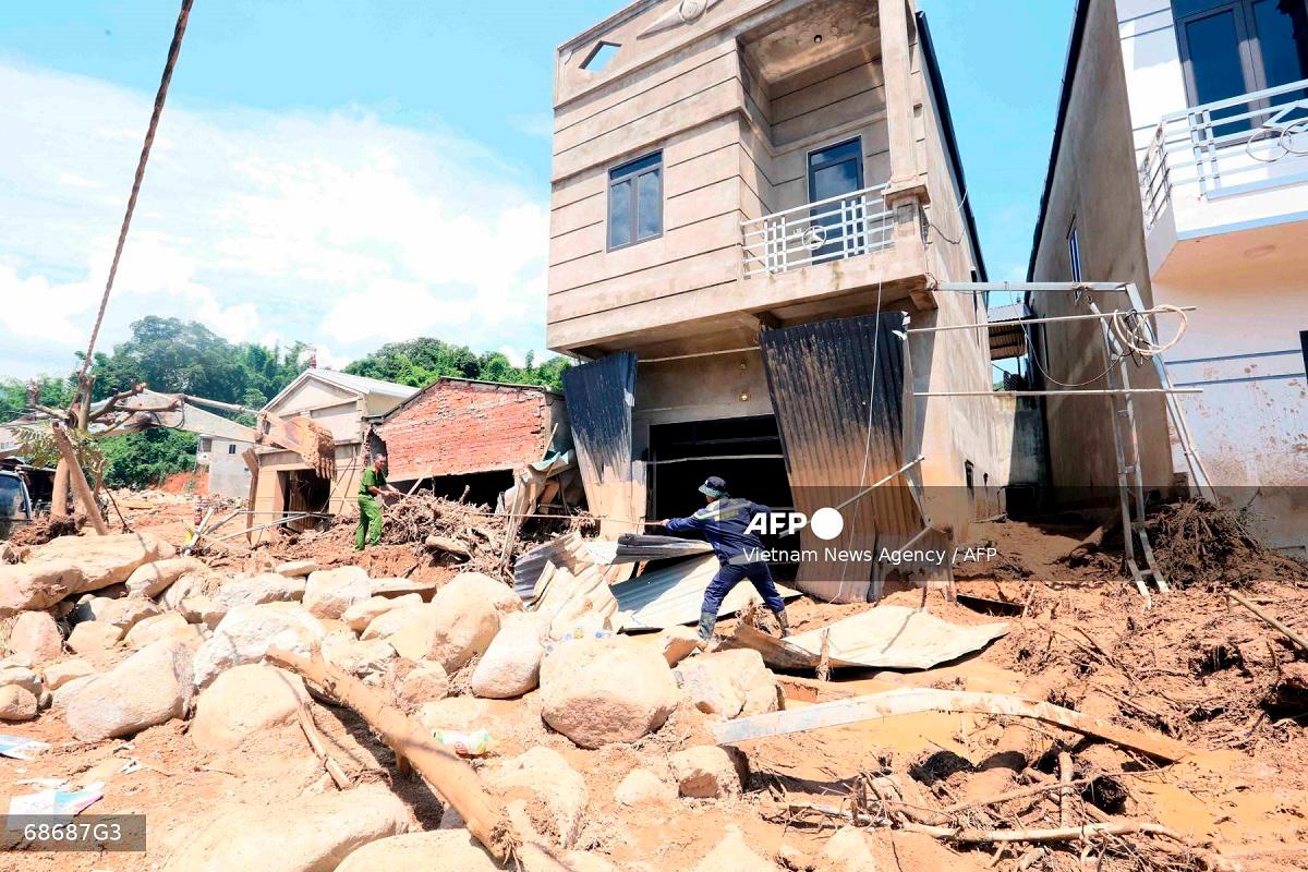 This photo taken by the Vietnam News Agency (VNA) on July 28, 2025 shows rescue workers clearing debris following flash floods in Son La province in northern Vietnam. A weekend flashflood in Vietnam's mountainous north killed five people and another remains missing, authorities said July 29. - AFP PHOTO / VIETNAM NEWS AGENCY