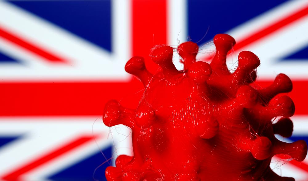 A 3D-printed coronavirus model is seen in front of a British flag on display in this illustration taken March 25, 2020. — Reuters