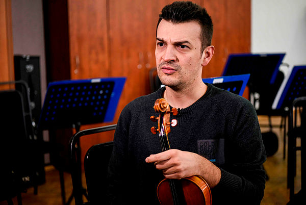 Kosovar professional violinist Visar Kuci speaks during an interview with AFP in Pristina — AFP