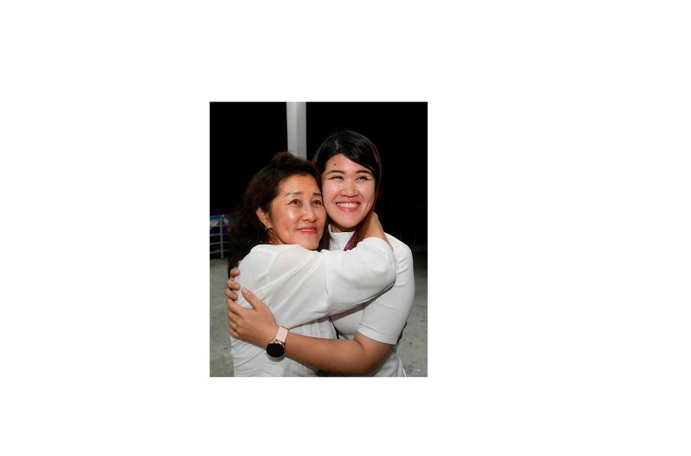 Vivian Wong Shir Yee (L) hugs her mother Datin Florence Chong, following victory in the Sandakan by-election last night.