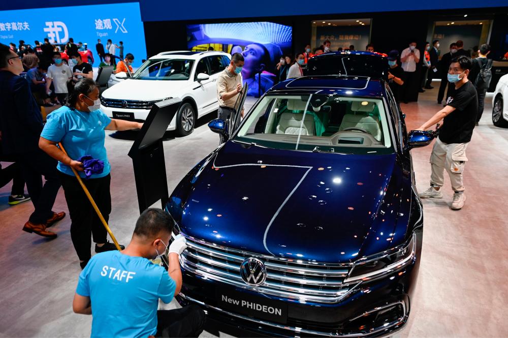 Workers cleaning a Volkswagen New Phideon car at the Beijing Auto Show on Saturday. China accounts for around 40% of the Wolfsburg-based carmaker's sales. – AFPPIX