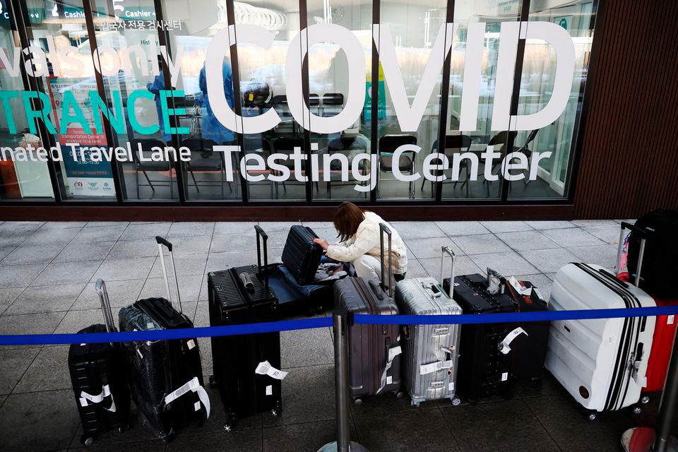 A Chinese tourist checks her luggage as she is waiting for her coronavirus disease (COVID-19) test result upon her arrival at the Incheon International Airport in Incheon, South Korea, January 4, 2023. REUTERSPIX