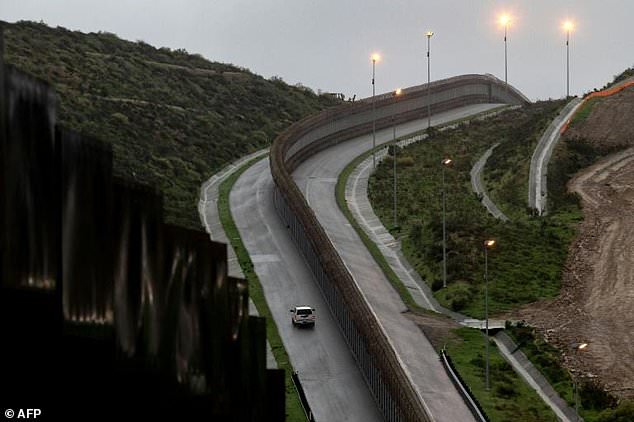 A US Border Patrol vehicle drives near a section of reinforced US-Mexico border fence near Tijuana, Mexico. — AFP