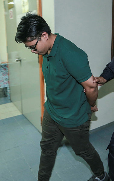Wan Nor Hayati Wan Mahmud was accompanied by a policeman at the Ampang magistrate’s court. — BBXpress.