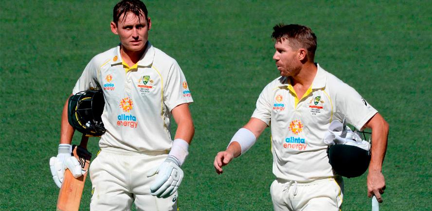 Australian batsmen Marnus Labuschagne (left) and David Warner leave the ground for the dinner break on the day one of the second cricket Test match of the Ashes series against England in Adelaide. – AFPPIX