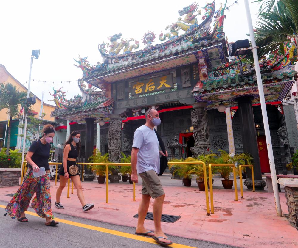 Tourists are seen passing by a Unesco World Heritage site at Lebuh Muntri at Georgetown, Penang. - Masry Che Ani/THESUNPIX