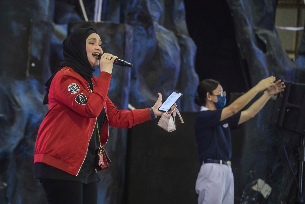 Siti Nurhaliza delivering the specially-written song at the event. – Adib Rawi Yahya/theSun