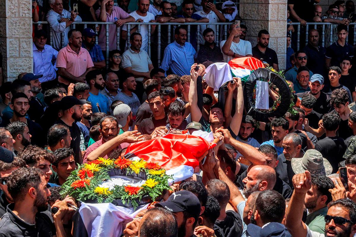 Mourners carry the bodies of dual US-Palestinian citizen Saif al-Din Kamil Abdul Karim Musalat and Palestinian Mohammad al-Shalabi during their funeral at the Palestinian village of Al-Mazraa Al-Sharqiya in the occupied West Bank on July 13, 2025, after they were reportedly killed by Israeli settlers two days prior. - Zain JAAFAR / AFP