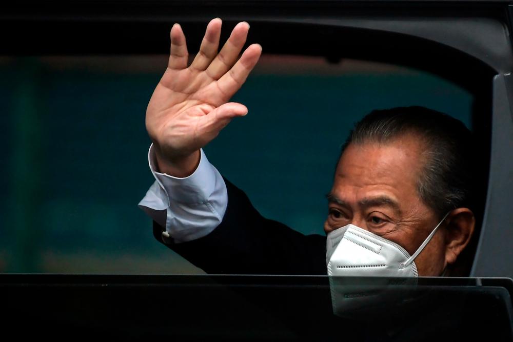 Muhyiddin waving to the media outside his home in Bukit Damansara this morning - Bernama