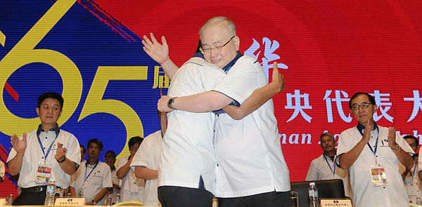 New MCA president Datuk Seri Wee Ka Siong embraces outgoing party leader Datuk Seri Liow Tiong Lai.