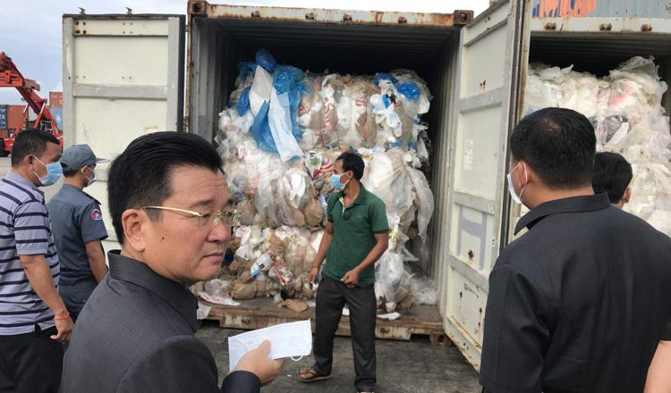 Kun Nhim, director-general of the General Department of Customs and Excise, and Environment Minister Say Samal inspect containers full of waste yesterday at the Sihanoukville Autonomous Port. - Khmer Times