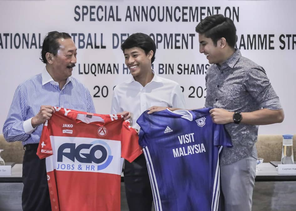 Berjaya Corporation Founder and Belgian football club KV Kortrijk owner Tan Sri Vincent Tan (left) together with striker Luqman Hakim Shamsudin (centre) after the signing. With them is Youth and Sports Minister Syed Saddiq Syed Abdul Rahman (right). — Sunpix by Adib Rawi