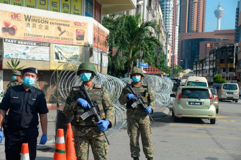 Military personnel stationed along Jalan Pudu today. The area is partially closed due to health screening being conducted by health officials, says police.