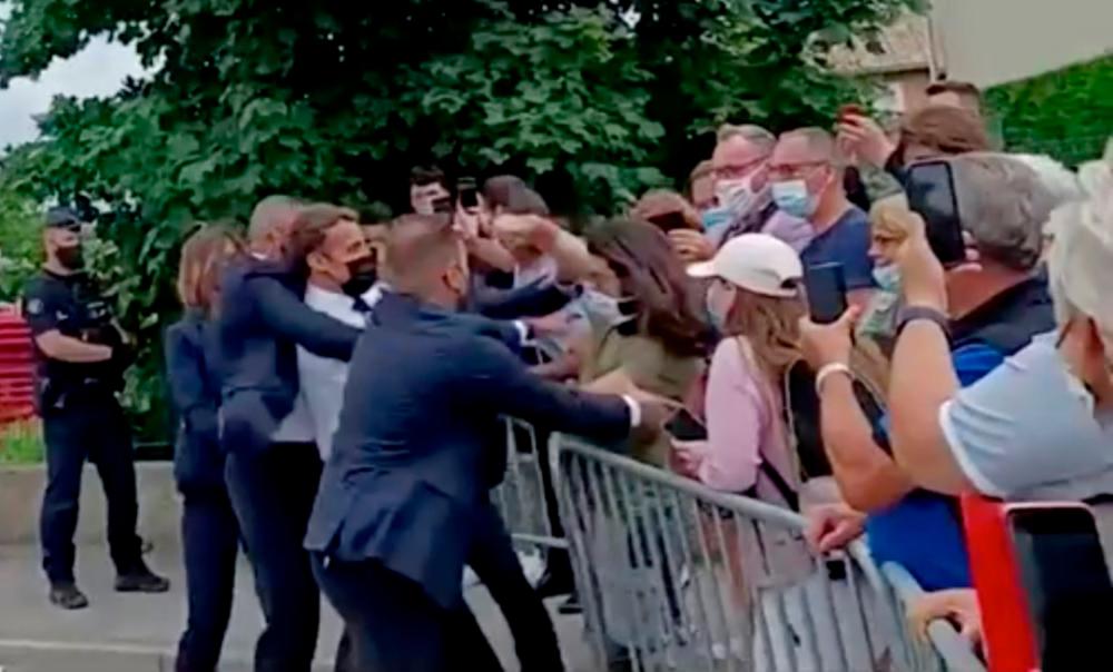 Macron slapped in the face during walkabout (Video)