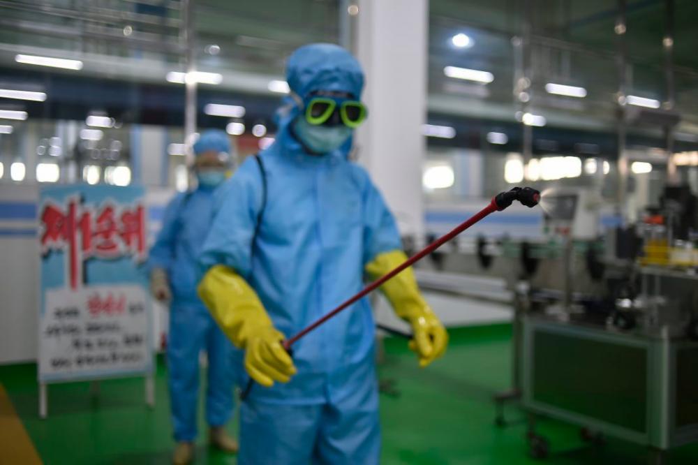 A health official disinfects the floor inside the Ryongaksan soap factory in Pyongyang on June 13/AFPPix