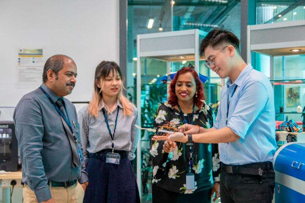 Team “Tremor X” and their supervisors check on the prototype of the low-cost self-stabilising spoon for people with Parkinson’s. From left - Suresh Gobee, Wong Heng Ying, Vickneswari Durairajah, and Ang Jia Ze.