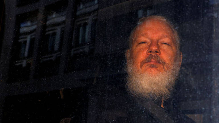 WikiLeaks founder Julian Assange is seen as he leaves a police station in London, Britain April 11, 2019. - Reuters