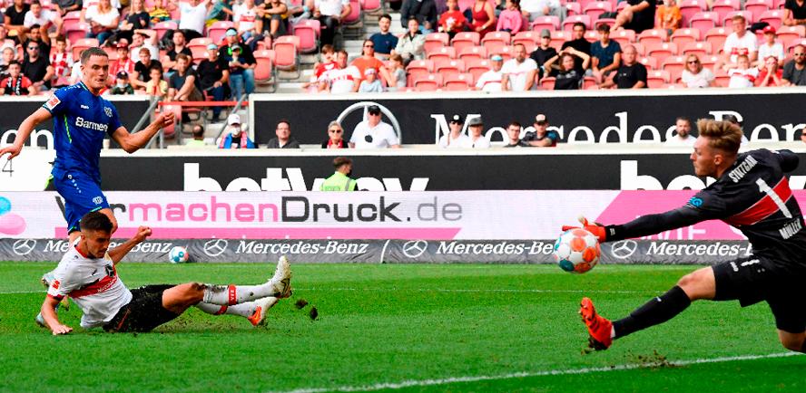 Leverkusen’s Florian Wirtz (left) scores the 3-1 past Stuttgart’s goalkeeper Florian Muller (right) during the German Bundesliga match. – AFPPIX
