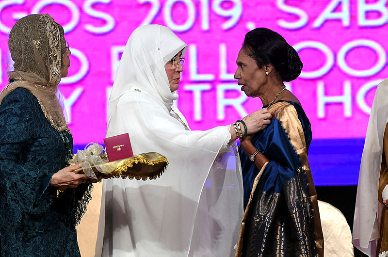 The Raja Permaisuri Agong Tunku Hajah Azizah Aminah Maimunah Iskandariah (2nd L) presents the Tun Fatimah Award from National Council of Women’s Organisations (NCWO), to Datuk Ramani Gurusamy (R) during the 57th Women’s Day, on Aug 24, 2019. — Bernama