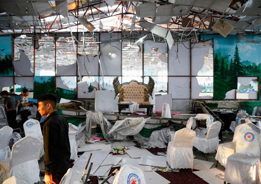 Workers of a wedding hall inspect after a blast in Kabul, Afghanistan August 18, 2019. - Reuters
