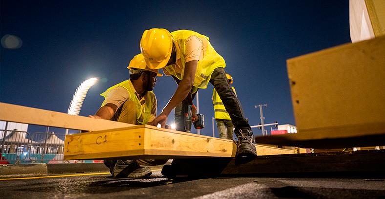 $!Labourers work to build a structure along a street in Doha ahead of the Qatar 2022 FIFA World Cup football tournament. – AFPPIX