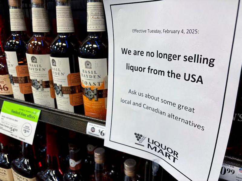 A sign notifying customers that a store will stop selling U.S. liquor from Tuesday, in response to U.S. President Donald Trump’s imposition of tariffs on Canada, is displayed on a shelf carrying U.S. alcohol in Winnipeg, Manitoba, Canada - REUTERSpix