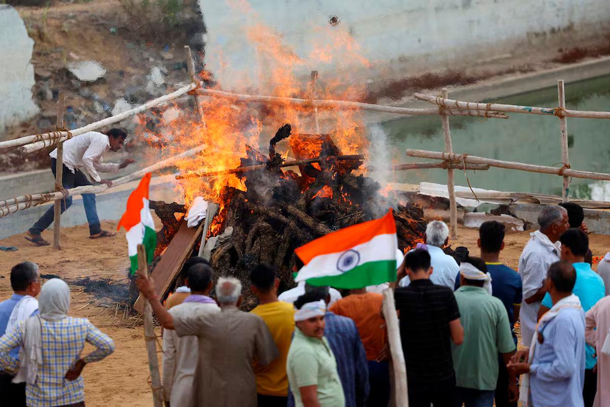 People attend the cremation of IAF (Indian Air Force) soldier Surendra Kumar who died during an attack on Udhampur, on the day of his funeral in Mahradasi village, Jhunjhunu in Rajasthan, India, May 11, 2025. REUTERS/Anushree Fadnavis