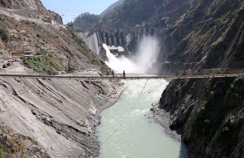 Labourers walk on a bridge near the 450-megawatt hydropower project located at Baglihar Dam on the Chenab river which flows from Indian Kashmir into Pakistan, at Chanderkote, about 145 km (90 miles) north of Jammu - REUTERSpix