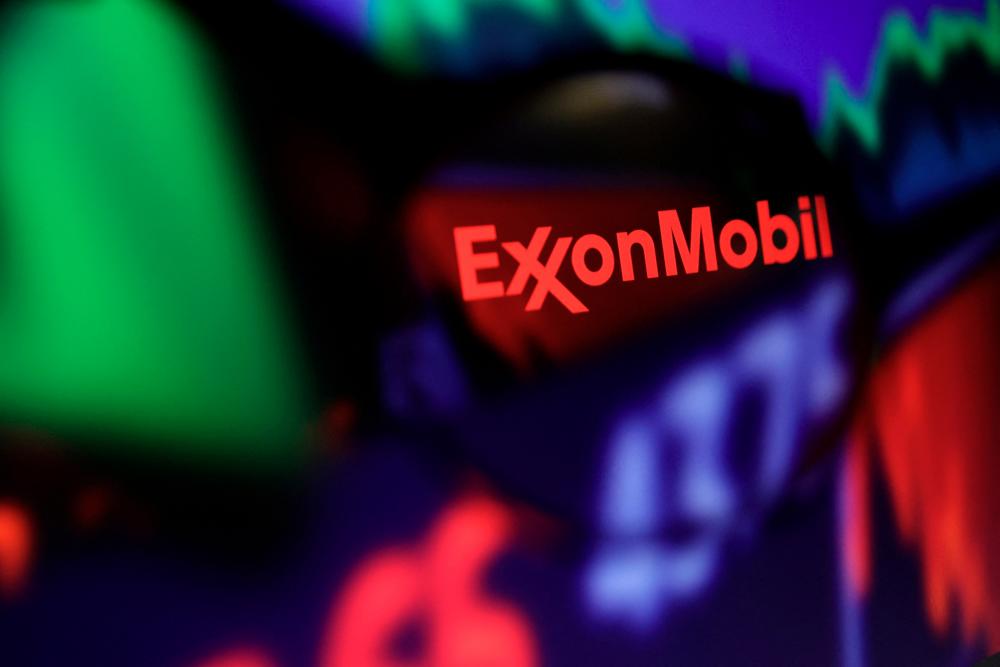 ExxonMobil’s logo and stock graph are seen through a magnifier displayed in this illustration. – Reuterspic