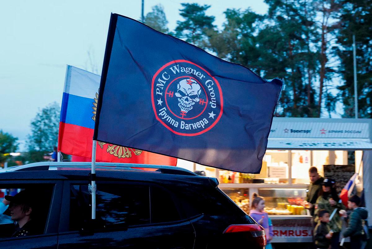 A flag with the logo of Wagner private mercenary group is attached to a car during an automobile rally at a patriotic festival marking Russia’s National Flag Day in the Moscow region, Russia, August 23, 2023. REUTERS/Yulia Morozova/File Photo