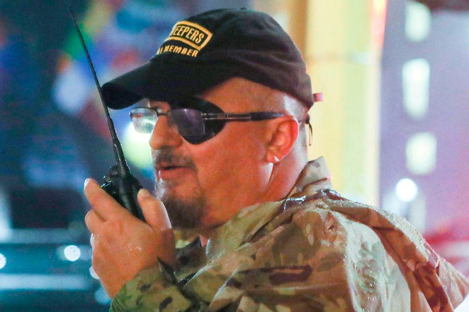 Oath Keepers militia founder Stewart Rhodes uses a radio as he departs with volunteers from a rally held by U.S. President Donald Trump in Minneapolis, Minnesota, U.S. October 10, 2019. REUTERSPIX